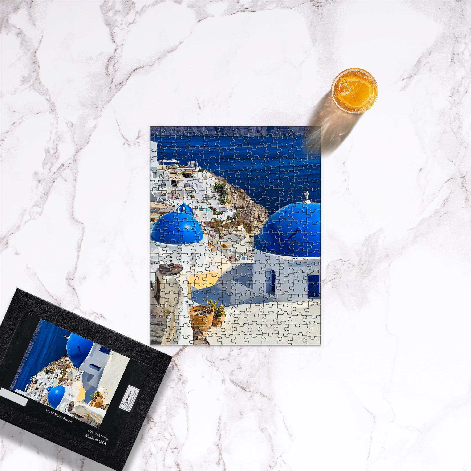 Sam Gilliss Visual Arts Santorini Blue Domes puzzle showing Oia Greece with vibrant blue domed buildings and scenic seascape background.