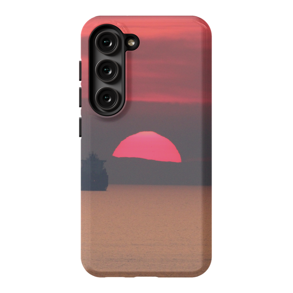 Premium cell phone case featuring the "Ship at Sunset, Corsica" artwork by Sam Gilliss Visual Arts, with a Mediterranean coast scene.