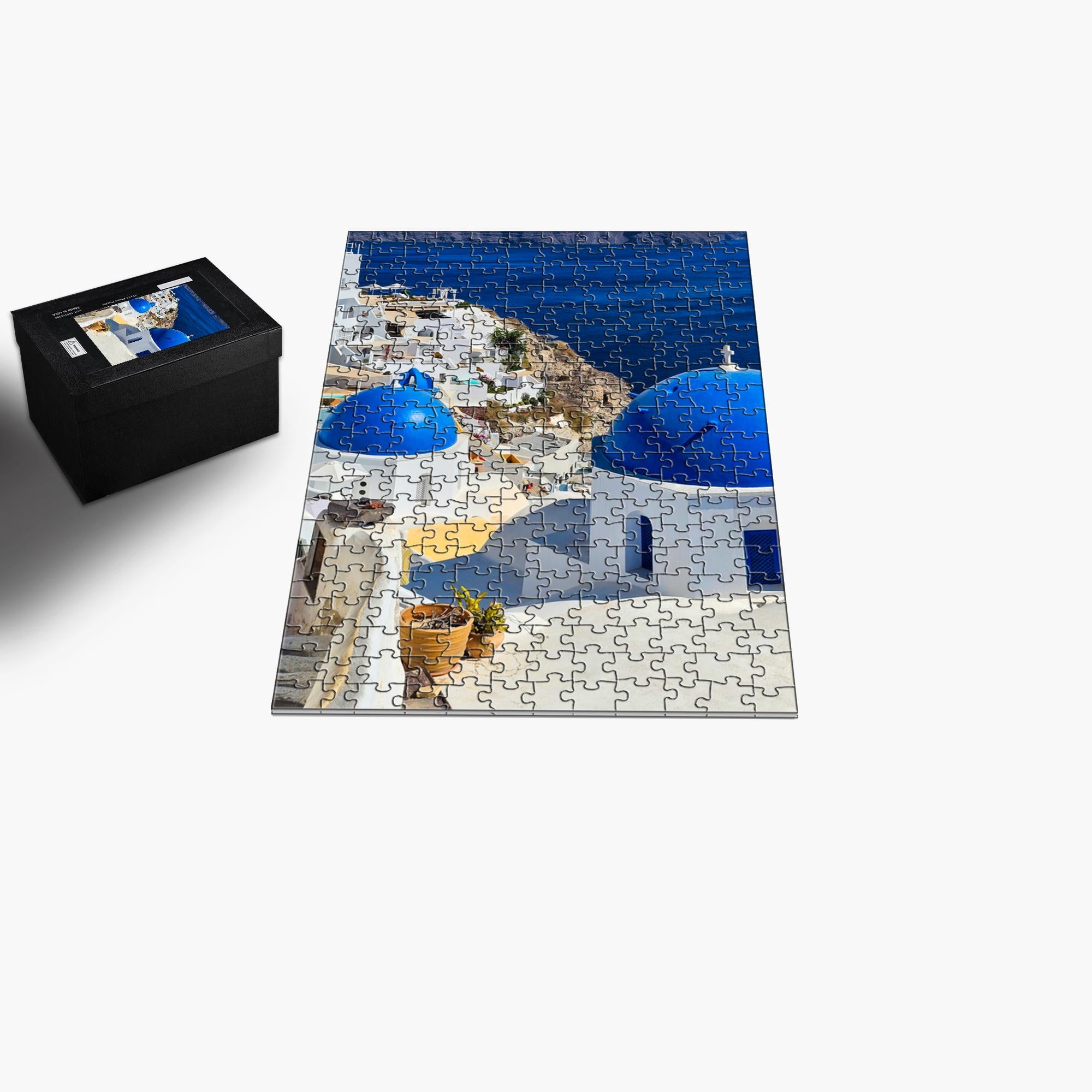 Santorini Blue Domes puzzle by Sam Gilliss, featuring colorful images of iconic Oia Greece blue-domed churches and scenic architecture.