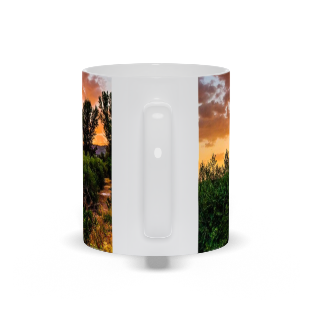 Ceramic coffee mug featuring a sunset over olive groves in central Spain, designed by Sam Gilliss Visual Arts.