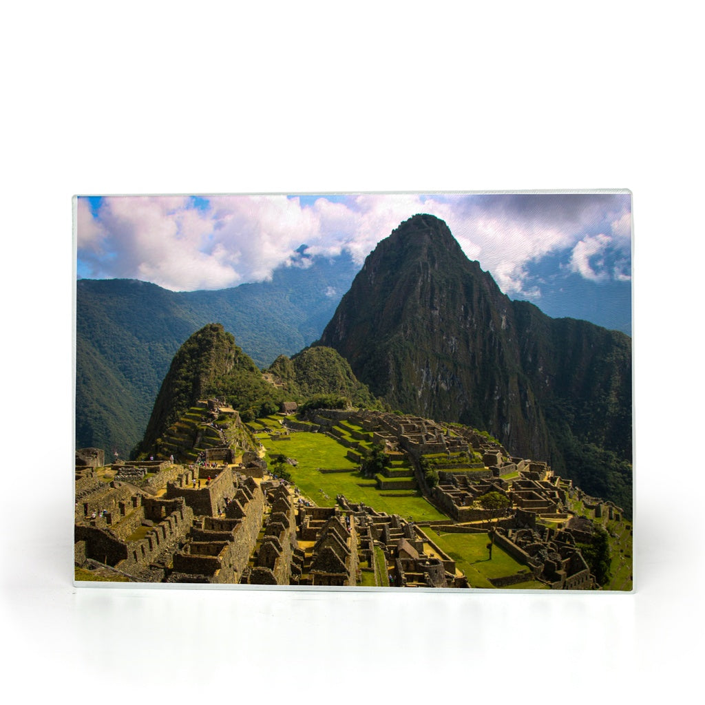 Tempered glass cutting board and placemat featuring Machu Picchu, Peru, with Incan Empire artwork by Sam Gilliss Visual Arts.