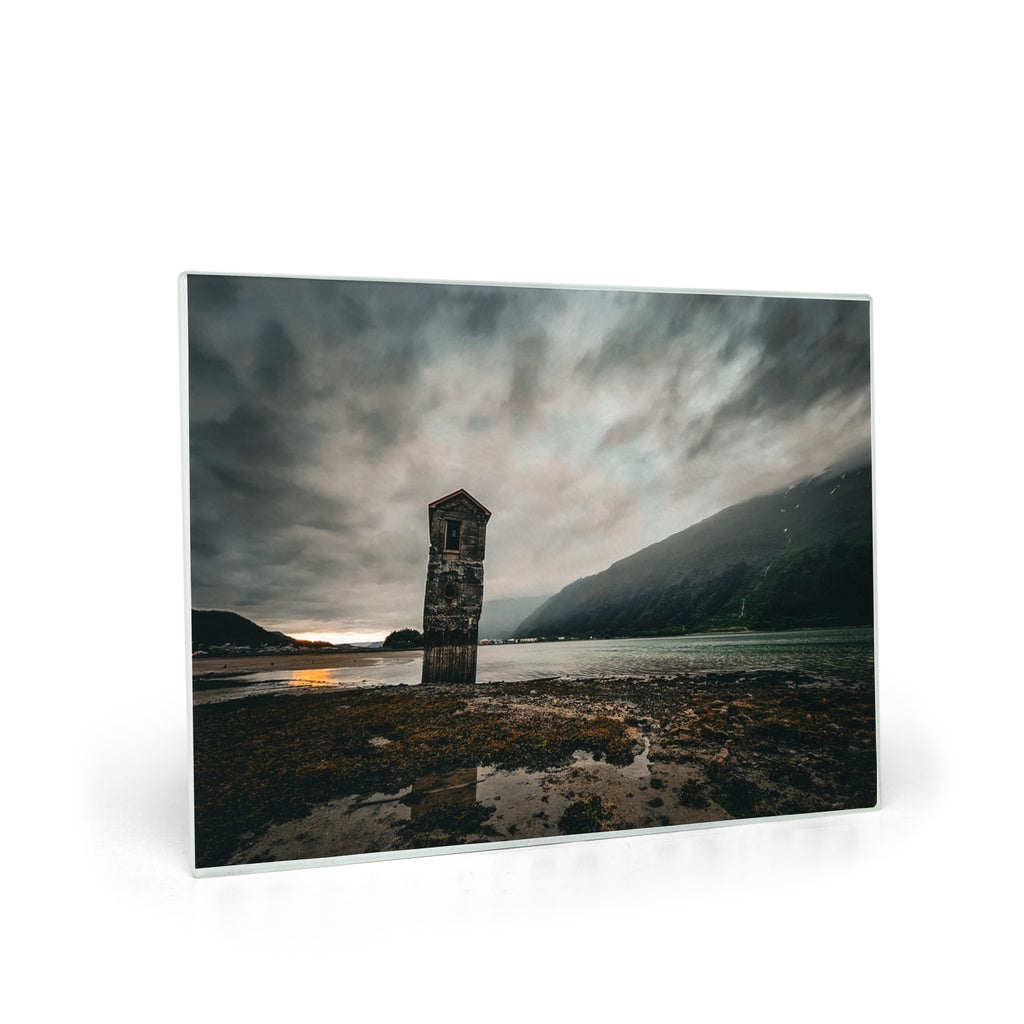 Tempered glass cutting board and placemat featuring a stormy sunset at Sandy Beach in Juneau, Alaska, by Sam Gilliss Visual Arts.