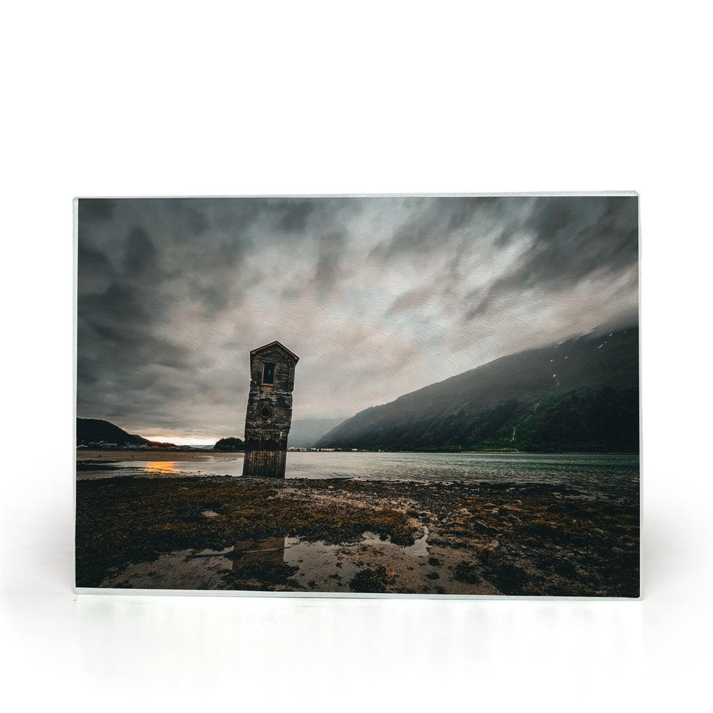 Tempered glass cutting board featuring a stormy sunset over Sandy Beach in Juneau, Alaska, by Sam Gilliss Visual Arts.